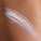 Model has applied Super Smooth onto their skin. Swiping it across.